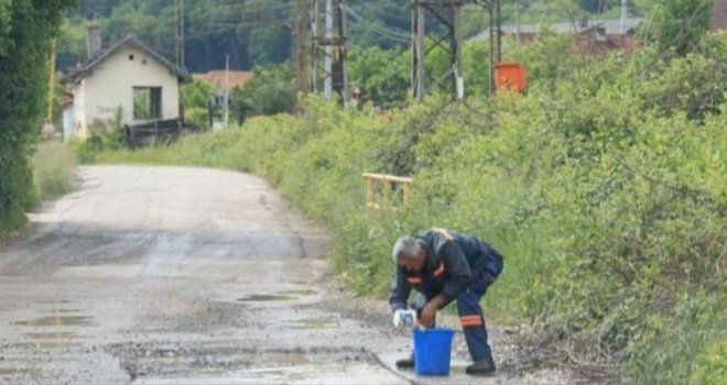 I ovo je BiH: Radnik kanticom od pavlake izbacuje vodu prije asfaltiranja